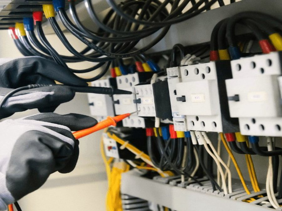 Chatham-Kent Generator Pros technician testing an automatic transfer switch during a standby generator install in Chatham-Kent, Ontario